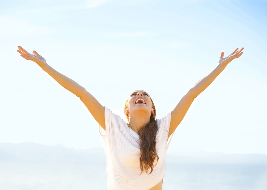 Woman smiling arms raised up to blue sky, celebrating freedom. Positive human emotions, face expression feeling life perception success, peace of mind concept. Free Happy girl on beach enjoying nature.jpeg